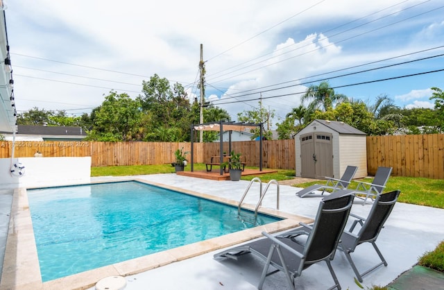 view of swimming pool with a storage shed and a patio