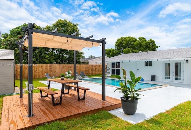 view of swimming pool featuring french doors, a pergola, and a deck