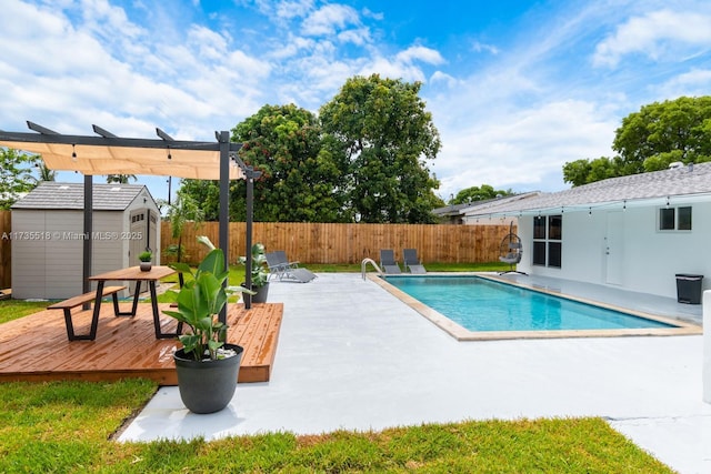 view of pool with a shed, a wooden deck, and a pergola