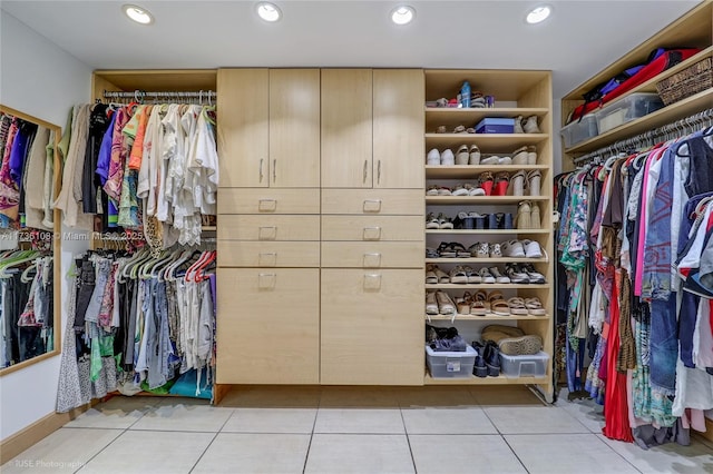 walk in closet with light tile patterned floors