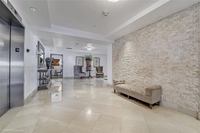 hall with elevator and light tile patterned flooring