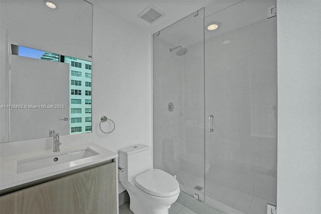 bathroom with vanity, an enclosed shower, and toilet