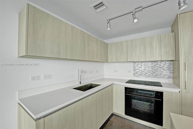 kitchen with sink, dark wood-type flooring, backsplash, black appliances, and light brown cabinetry