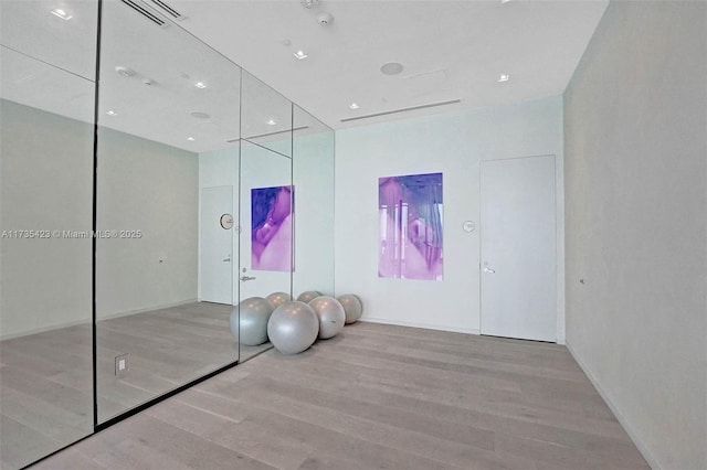 exercise area featuring light hardwood / wood-style flooring