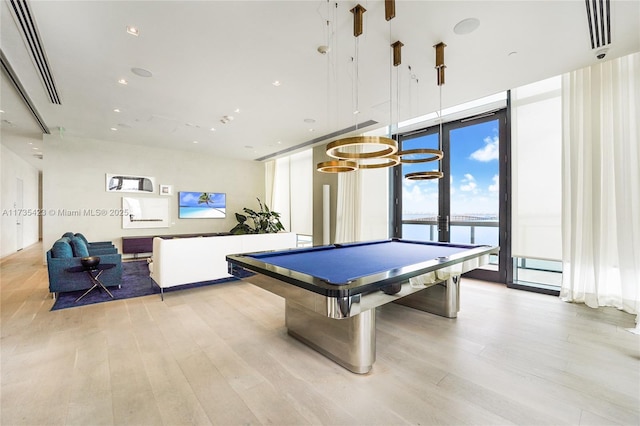 playroom featuring floor to ceiling windows, a water view, light hardwood / wood-style floors, and billiards