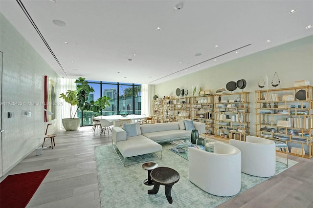 living room with expansive windows and light hardwood / wood-style floors