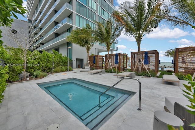 view of swimming pool featuring a playground and a patio area