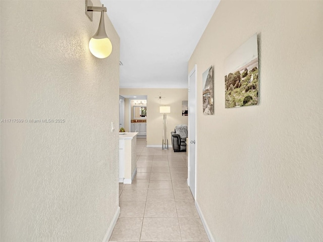 hall with light tile patterned floors