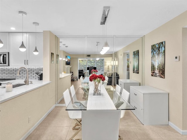 tiled dining room featuring sink