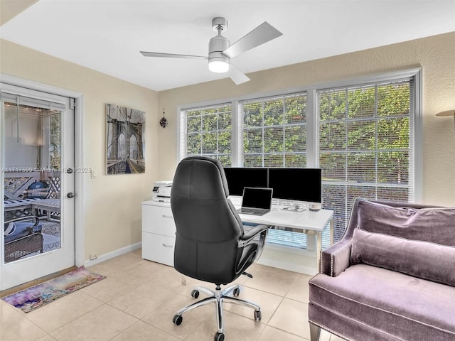 office space with ceiling fan and light tile patterned floors