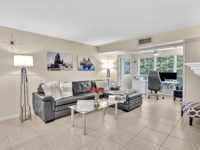 tiled living room featuring ceiling fan