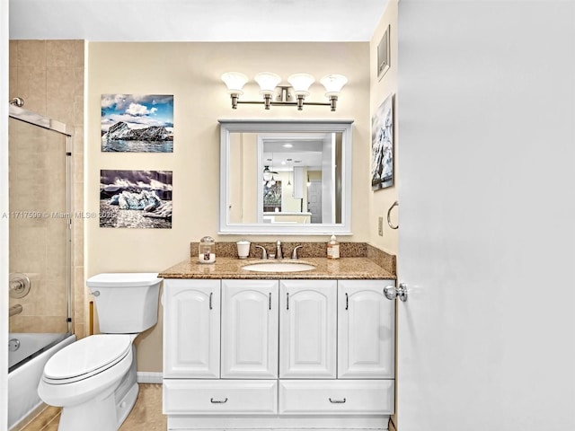 full bathroom with bath / shower combo with glass door, vanity, and toilet