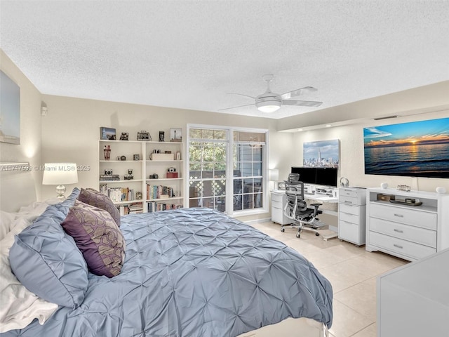 bedroom featuring ceiling fan, a textured ceiling, and light tile patterned floors