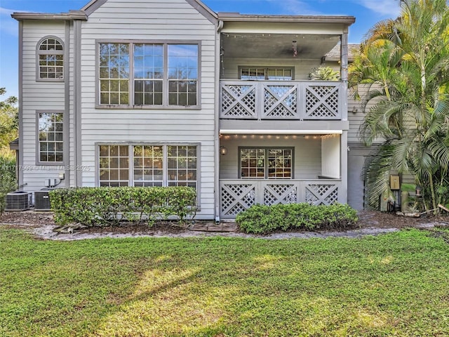 view of front of property with central AC unit and a front yard