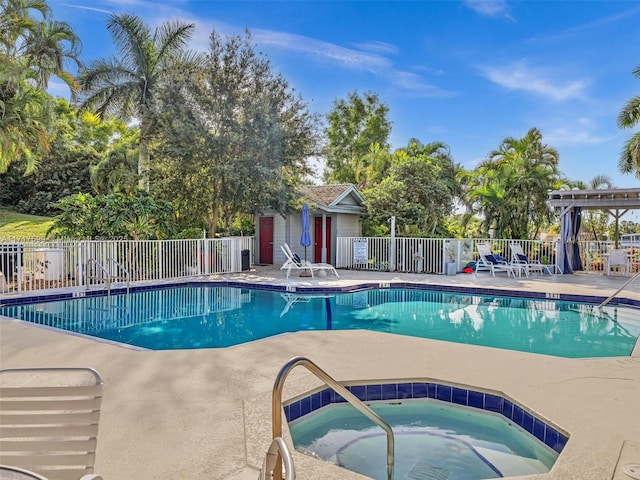 view of pool with a community hot tub and a patio