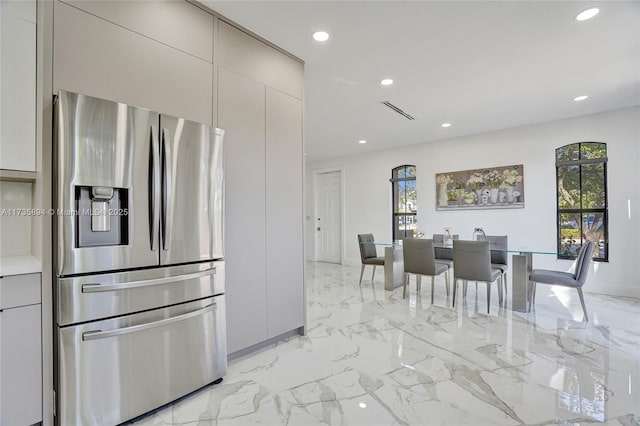 kitchen featuring stainless steel fridge with ice dispenser