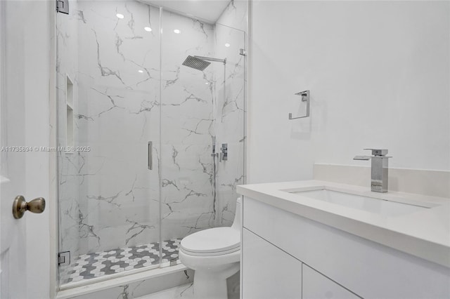 bathroom featuring vanity, walk in shower, and toilet