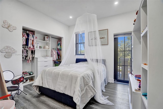 bedroom with hardwood / wood-style floors and a closet