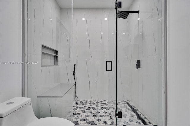 bathroom with toilet and a shower with shower door