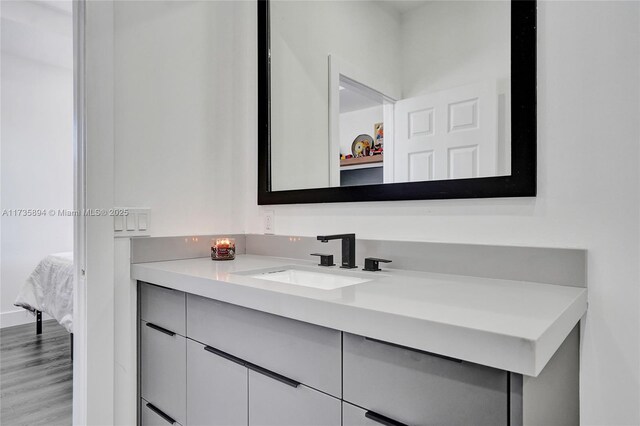 bathroom with hardwood / wood-style flooring and vanity