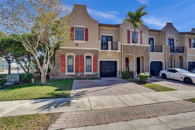 view of front of house with a garage and a front lawn