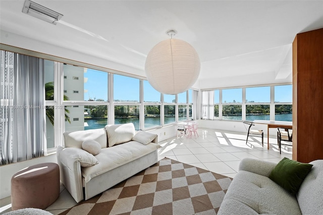 sunroom / solarium featuring a water view