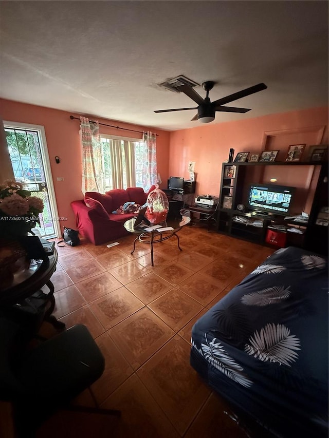 tiled living room featuring ceiling fan