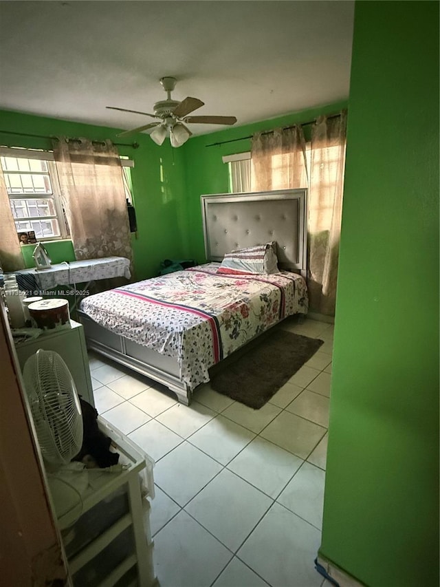 tiled bedroom with ceiling fan