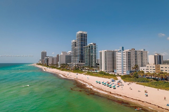 birds eye view of property featuring a view of the beach and a water view