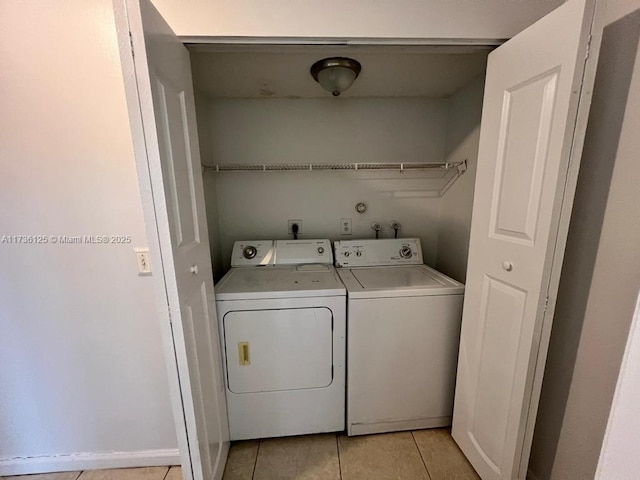 clothes washing area featuring independent washer and dryer and light tile patterned floors