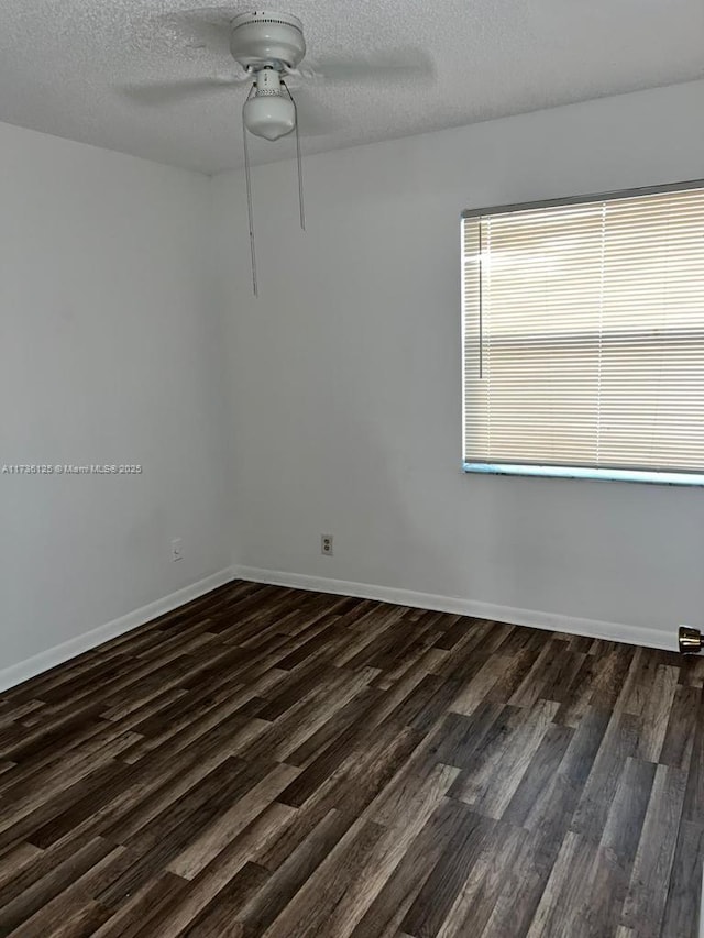 unfurnished room featuring dark hardwood / wood-style floors, a textured ceiling, and ceiling fan