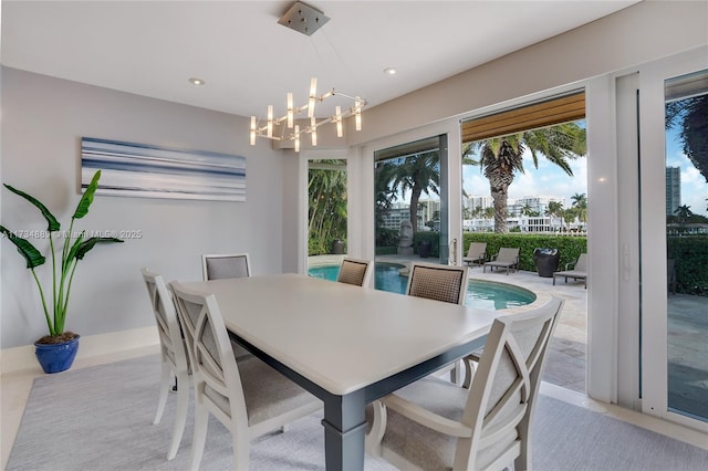 dining area with recessed lighting and an inviting chandelier