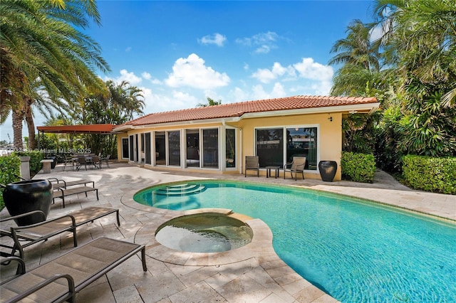 view of swimming pool with an in ground hot tub and a patio