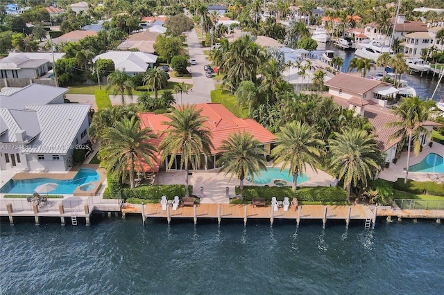 bird's eye view featuring a water view and a residential view