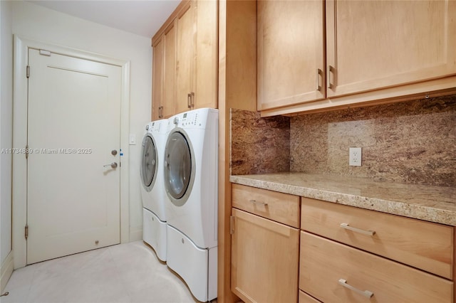 laundry room with cabinets and washing machine and clothes dryer