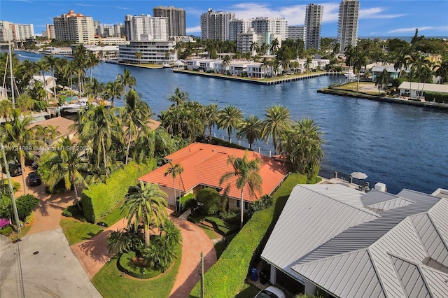 drone / aerial view featuring a view of city and a water view