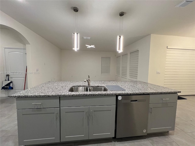 kitchen featuring pendant lighting, sink, stainless steel dishwasher, and a center island with sink