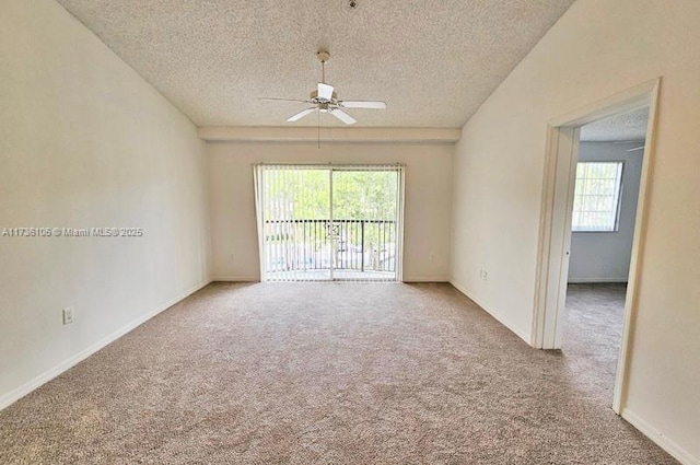 unfurnished room featuring ceiling fan, carpet flooring, and a textured ceiling