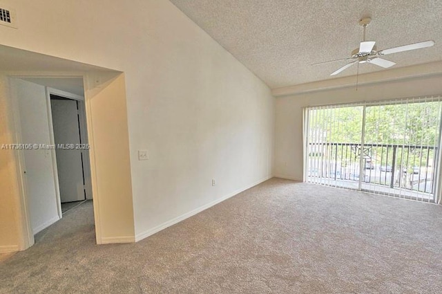 carpeted empty room with ceiling fan, high vaulted ceiling, and a textured ceiling