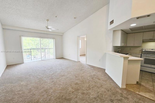 interior space with ceiling fan, high vaulted ceiling, light carpet, and a textured ceiling