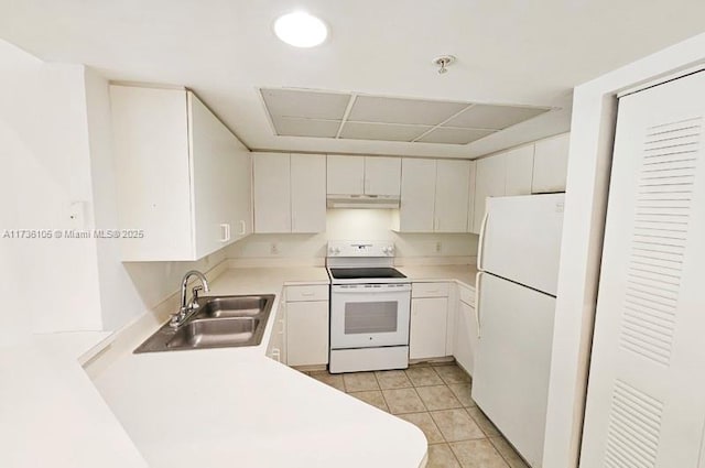 kitchen with sink, light tile patterned floors, white cabinets, and white appliances