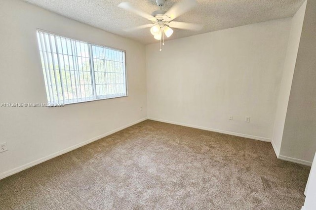 carpeted spare room featuring ceiling fan and a textured ceiling