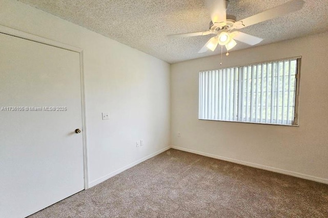 unfurnished room with ceiling fan, carpet floors, and a textured ceiling