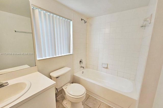 full bathroom featuring tiled shower / bath, vanity, toilet, and tile patterned floors