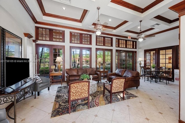 living room with a towering ceiling, coffered ceiling, ceiling fan, crown molding, and french doors