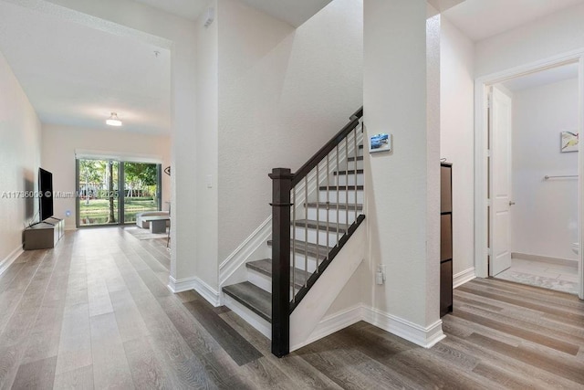 stairs with hardwood / wood-style flooring