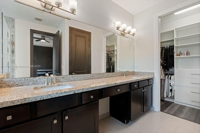 bathroom with hardwood / wood-style flooring, ceiling fan, and vanity