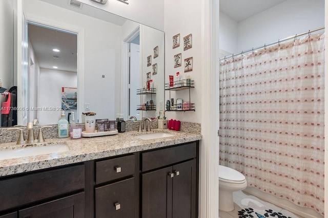 bathroom featuring vanity and toilet