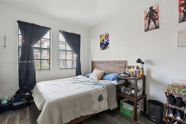 bedroom with dark wood-type flooring