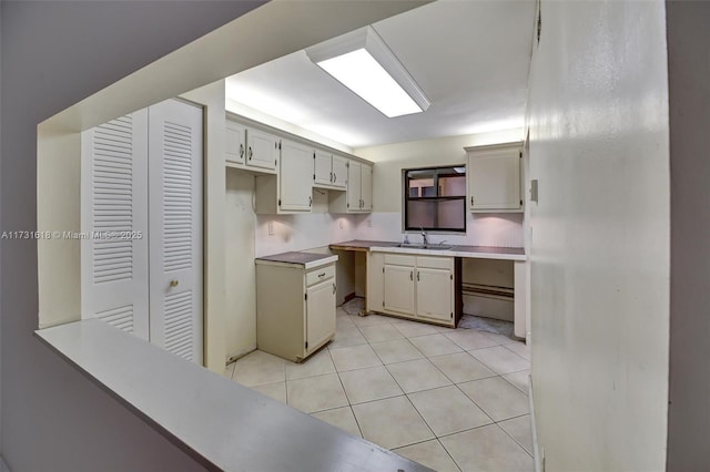 kitchen featuring light tile patterned flooring and sink